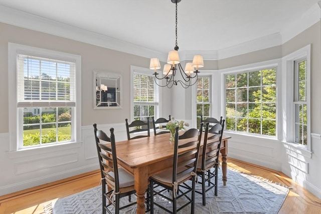 356 Grafton St, Shrewsbury, MA 01545 - dining area featuring a chandelier, healthy amount of natural light, a wainscoted wall, ornamental molding, and light wood-style flooring