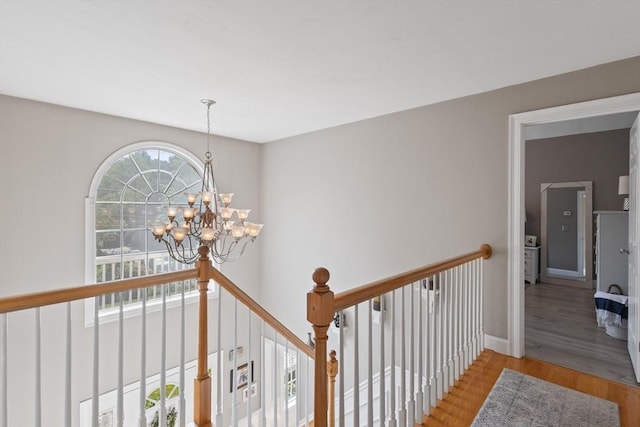 356 Grafton St, Shrewsbury, MA 01545 - corridor with a chandelier, wood finished floors, and an upstairs landing