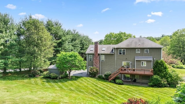 356 Grafton St, Shrewsbury, MA 01545 - back of house with stairway, a wooden deck, a chimney, and a yard