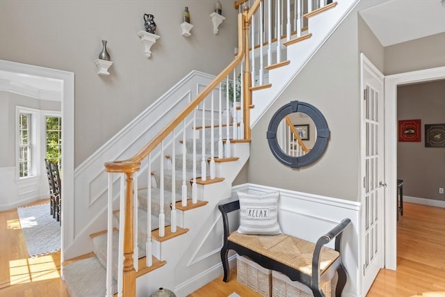 356 Grafton St, Shrewsbury, MA 01545 - stairway with wood finished floors, a wainscoted wall, and a decorative wall