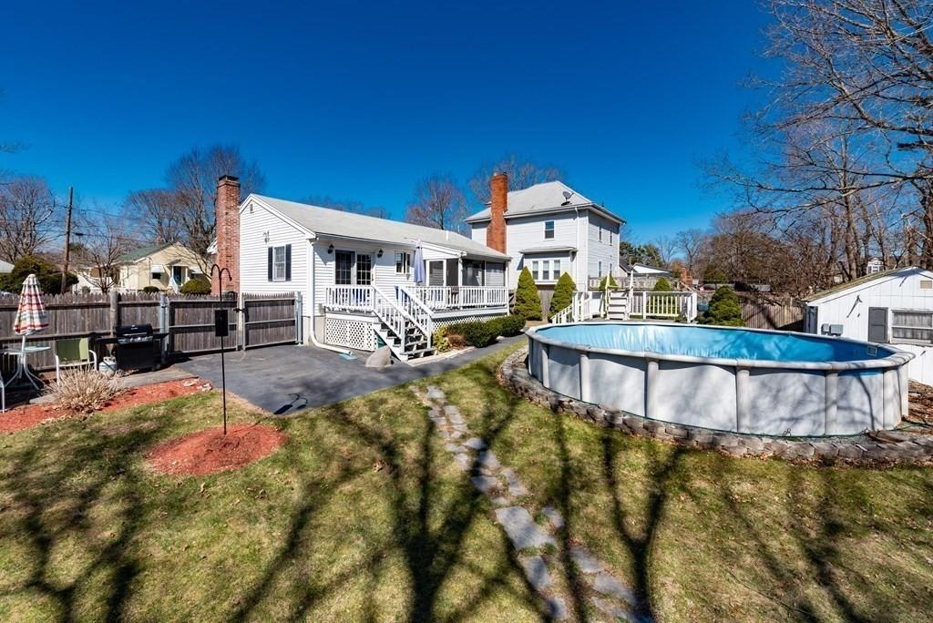 32 Hampden Ave, Brockton, MA 02301 - rear view of house with a deck, a sunroom, a patio, and a chimney