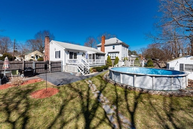 32 Hampden Ave, Brockton, MA 02301 - rear view of house with a deck, a sunroom, a patio, and a chimney
