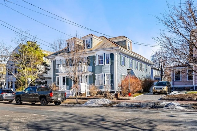 traditional style home featuring a balcony