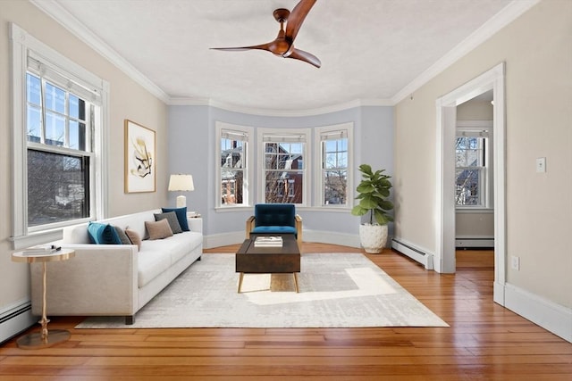 sitting room with ornamental molding, hardwood / wood-style floors, and a baseboard radiator