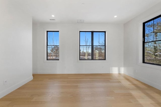 empty room with light hardwood / wood-style flooring