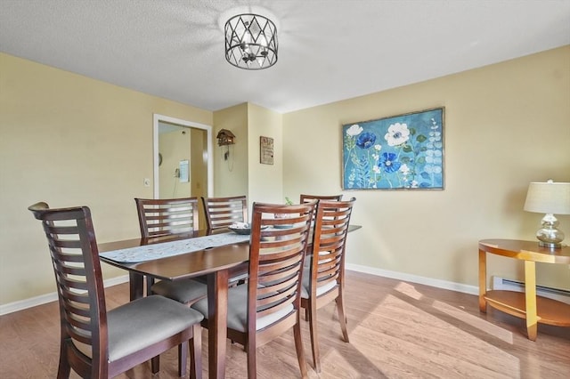 34 S Riverview St, Haverhill, MA 01835 - dining area with wood finished floors, baseboards, and a baseboard radiator