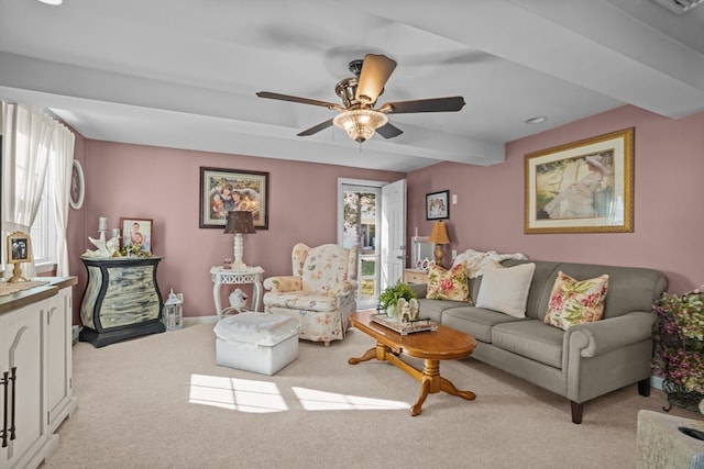 carpeted living room with ceiling fan