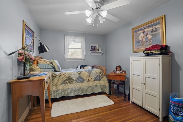 bedroom with ceiling fan and dark hardwood / wood-style flooring