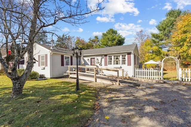 view of front of home with a front lawn and a deck