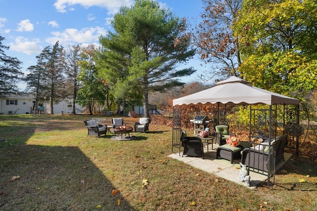 view of yard featuring an outdoor living space with a fire pit and a patio