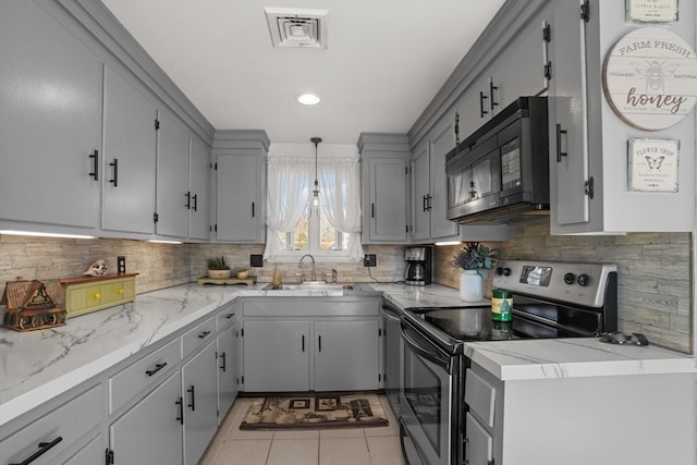 kitchen featuring sink, tasteful backsplash, gray cabinetry, light tile patterned floors, and stainless steel electric range oven