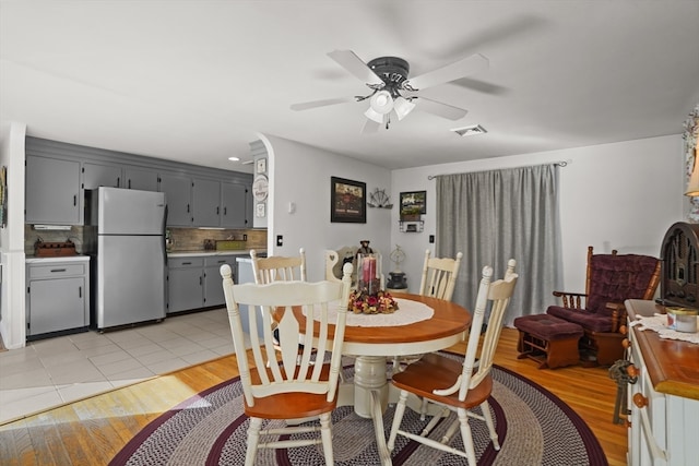 dining space featuring light hardwood / wood-style floors and ceiling fan