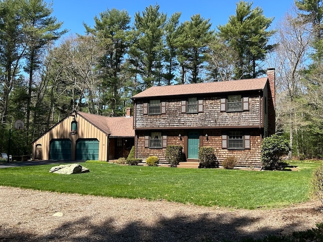 view of front of property with a garage and a front lawn