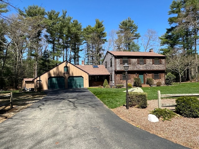 view of front of home featuring a garage and a front lawn