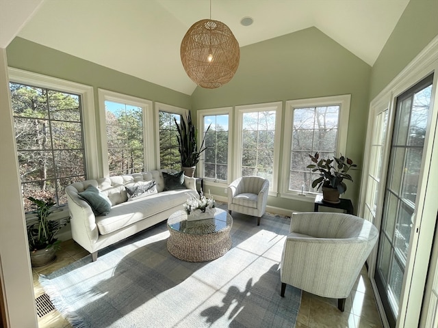 sunroom / solarium with a healthy amount of sunlight and vaulted ceiling