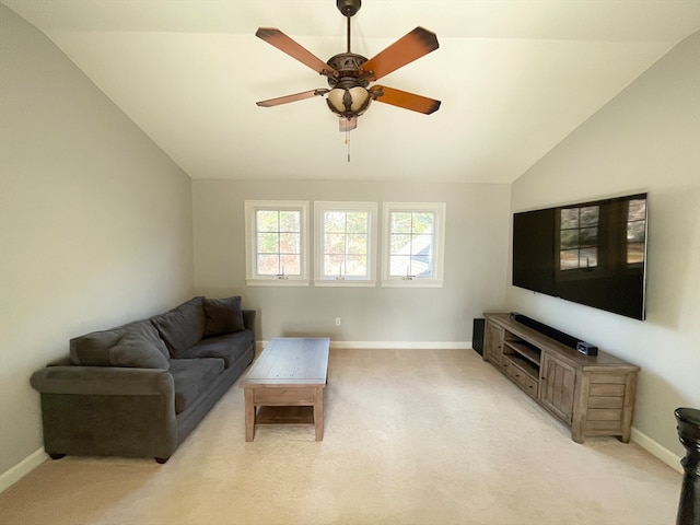 living room featuring ceiling fan, light carpet, and vaulted ceiling