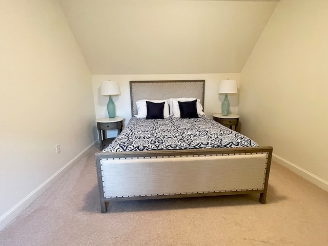 bedroom with light colored carpet and lofted ceiling