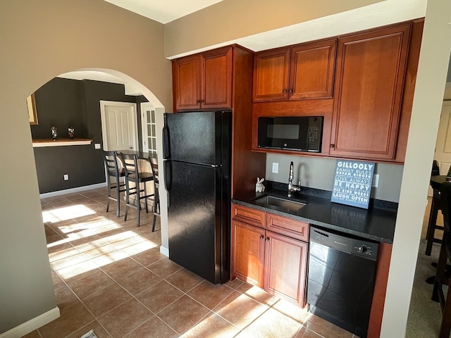 kitchen with tile patterned floors, sink, and black appliances