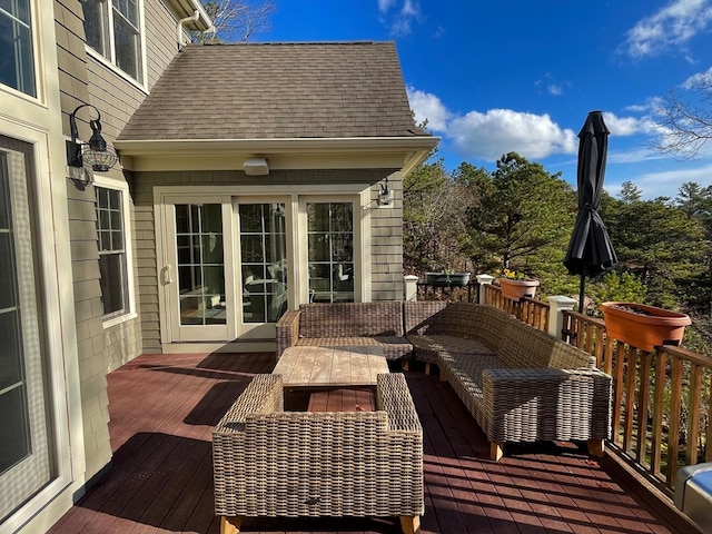 wooden terrace with an outdoor living space