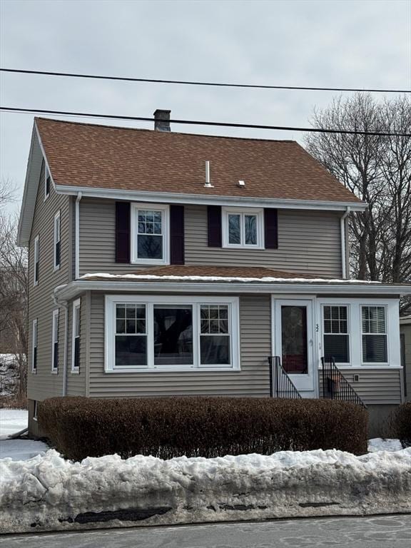 traditional-style home featuring a chimney