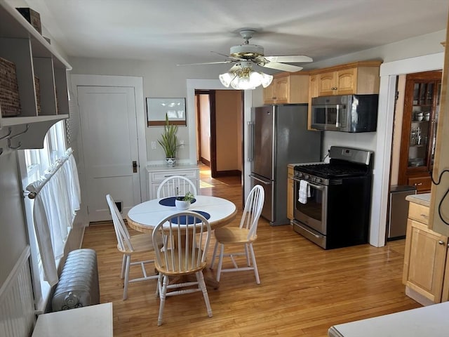 kitchen featuring light wood-style floors, light brown cabinets, stainless steel appliances, and light countertops