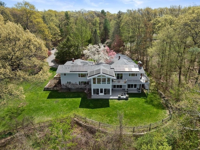 aerial view of property and surrounding area with a heavily wooded area
