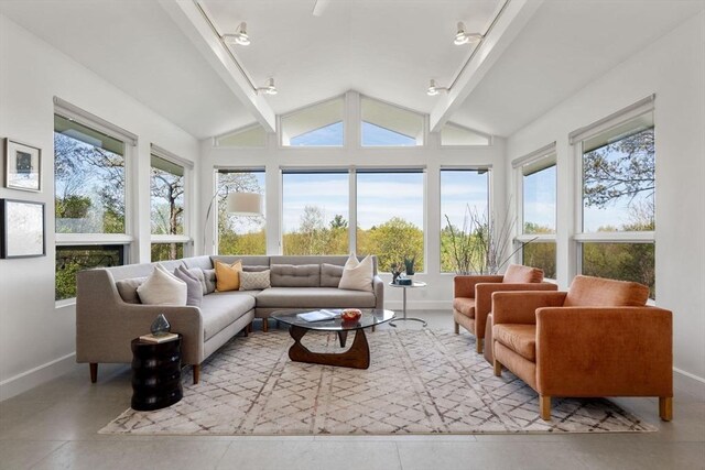 sunroom / solarium with baseboards and track lighting