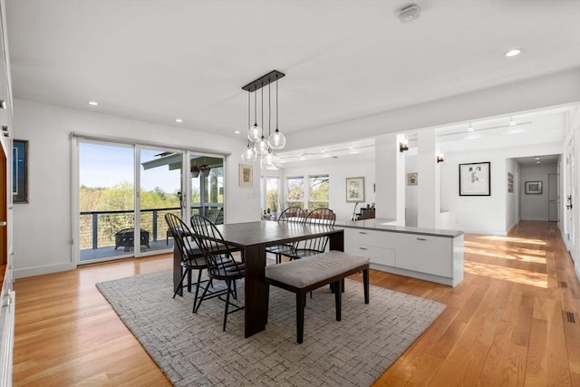 dining area with light wood-style flooring, recessed lighting, and baseboards
