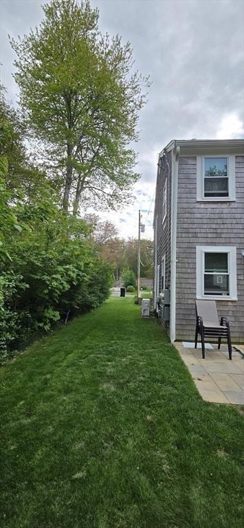 46 Beach Rd Unit B, Yarmouth, MA 02673 - view of green lawn featuring a patio area