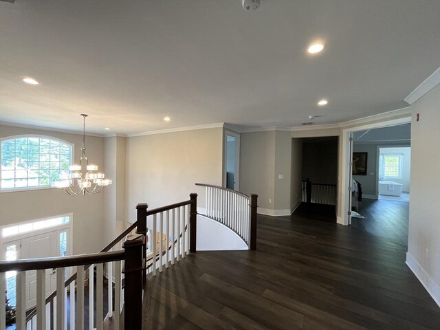 hall with an upstairs landing, dark wood-type flooring, recessed lighting, baseboards, and ornamental molding