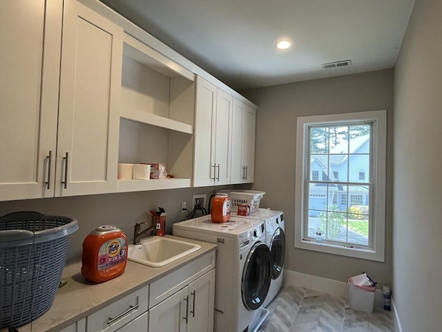 clothes washing area with separate washer and dryer, cabinet space, baseboards, and recessed lighting