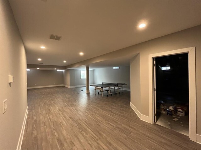 below grade area with wood finished floors, recessed lighting, and baseboards