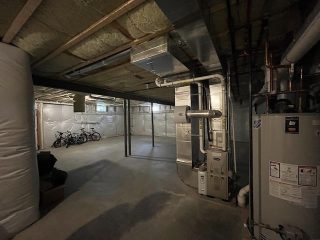 unfinished below grade area featuring water heater