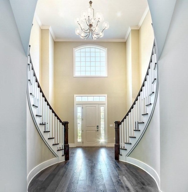 entryway featuring a chandelier, stairs, dark wood finished floors, baseboards, and a high ceiling