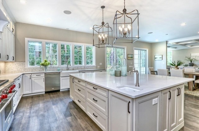 kitchen featuring a sink, appliances with stainless steel finishes, dark wood-style flooring, white cabinets, and recessed lighting