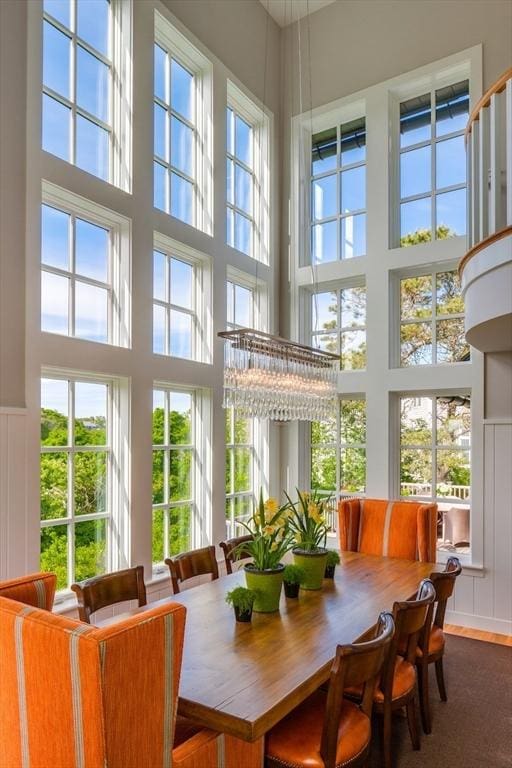 sunroom / solarium with a chandelier