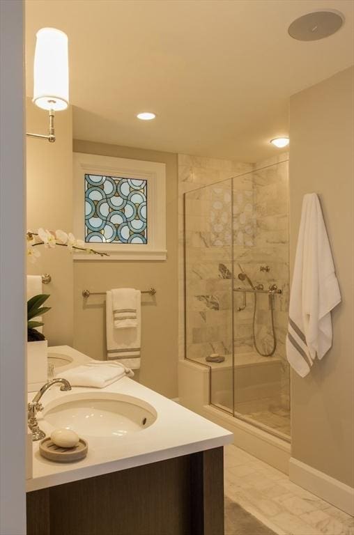 bathroom with vanity and a shower with shower door