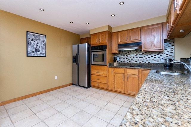 154 Lynnway Unit 511, Lynn, MA 01902 - kitchen with fridge with ice dispenser, stainless steel oven, under cabinet range hood, black electric stovetop, and backsplash