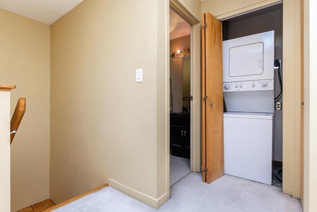 154 Lynnway Unit 511, Lynn, MA 01902 - washroom featuring stacked washing machine and dryer and light carpet