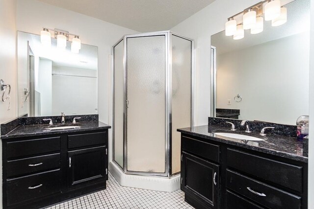 154 Lynnway Unit 511, Lynn, MA 01902 - full bathroom with a shower stall, tile patterned floors, and two vanities