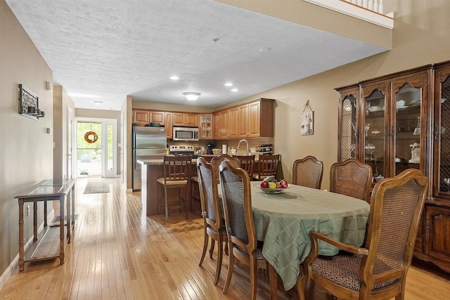 108 Green Briar Rd Unit 108, Fitchburg, MA 01420 - dining room with light wood-style floors, recessed lighting, a textured ceiling, and baseboards