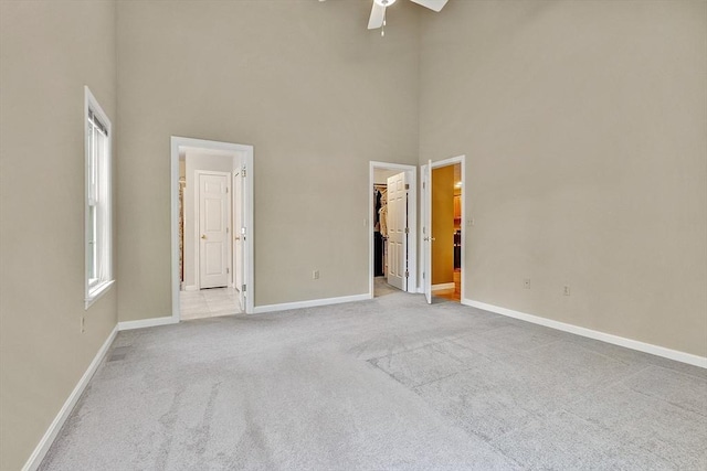 108 Green Briar Rd Unit 108, Fitchburg, MA 01420 - unfurnished bedroom featuring a high ceiling, a spacious closet, light colored carpet, and baseboards