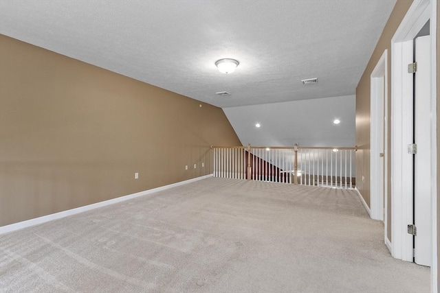 108 Green Briar Rd Unit 108, Fitchburg, MA 01420 - empty room with light carpet, baseboards, a textured ceiling, and vaulted ceiling