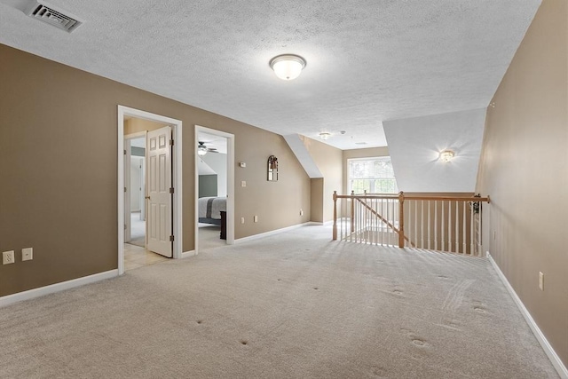 108 Green Briar Rd Unit 108, Fitchburg, MA 01420 - empty room with carpet flooring, a textured ceiling, baseboards, and a ceiling fan