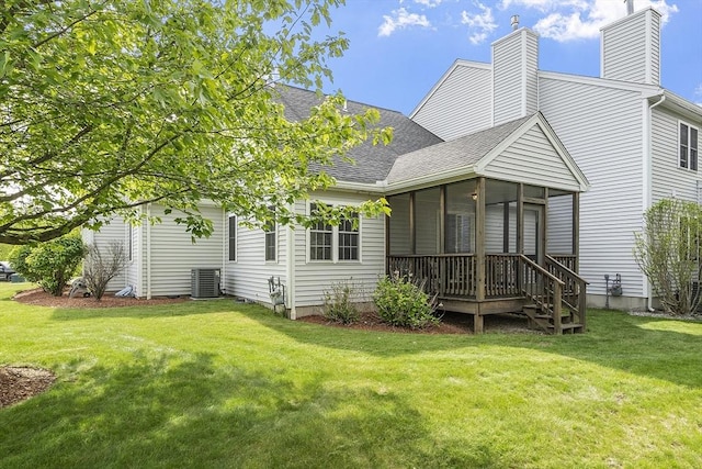 108 Green Briar Rd Unit 108, Fitchburg, MA 01420 - back of property featuring roof with shingles, a sunroom, a yard, a chimney, and cooling unit