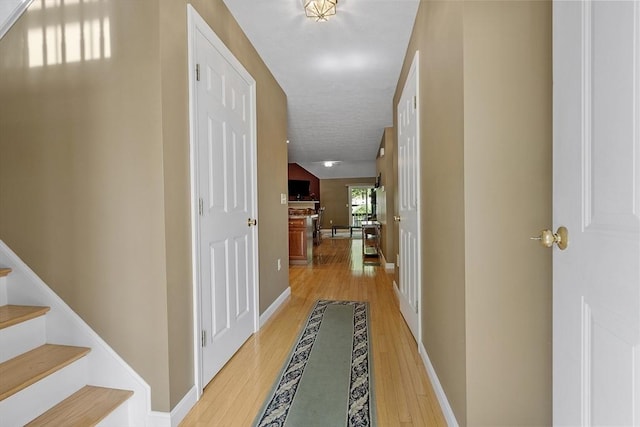 108 Green Briar Rd Unit 108, Fitchburg, MA 01420 - hallway featuring light wood-style flooring, stairs, and baseboards