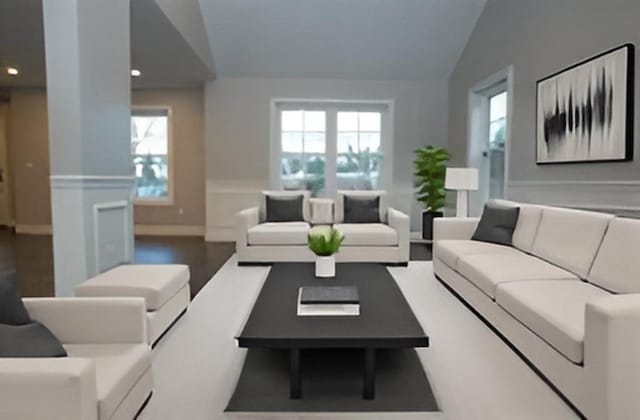 living room featuring lofted ceiling and wood-type flooring