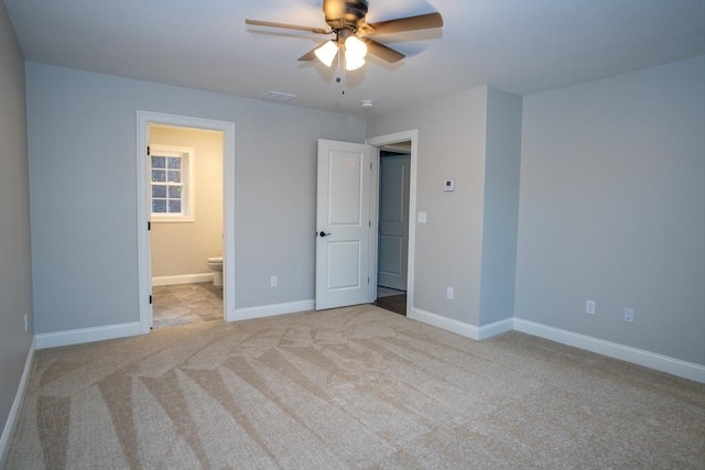 unfurnished bedroom featuring ceiling fan, connected bathroom, and light carpet