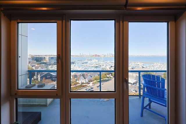 doorway to outside featuring a water view and a wealth of natural light