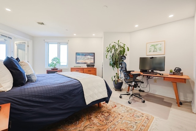 bedroom with light wood-type flooring and french doors